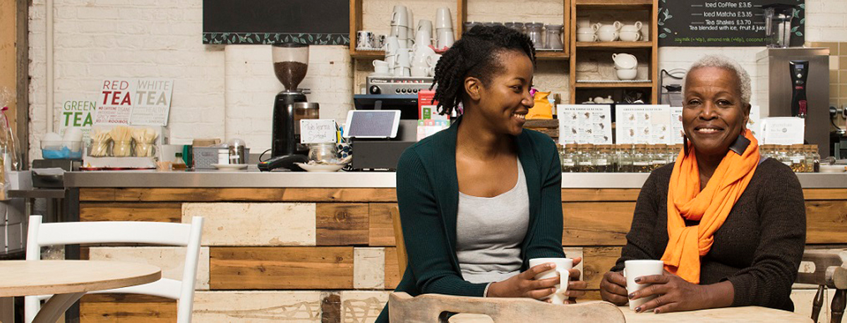Two women chatting over coffee