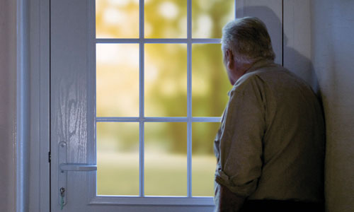 An older man looking out of a window