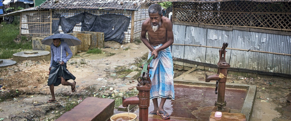 A man pumping water into a bucket
