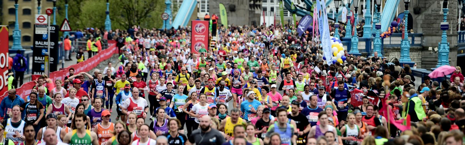 Huge crowd of runners racing across Tower Bridge