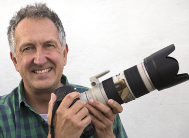 Zoologist Mark Carwardine, pictured holding a camera.