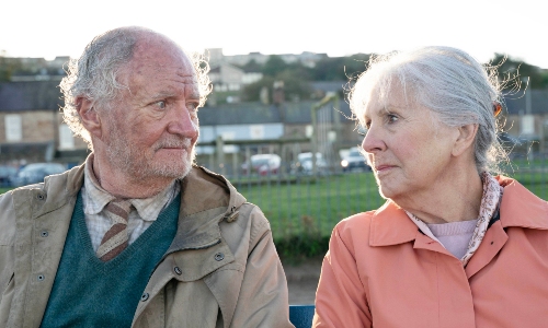 Jim Broadbent and Dame Penelope Wilton, looking at and smiling at each other