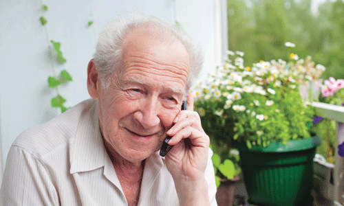 An older man speaking on the phone