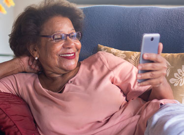 Woman smiling and holding a smartphone