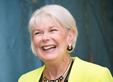 Woman in a green blazer laughing