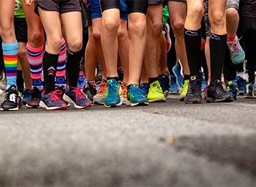 Runners' legs with colourful socks and shoes